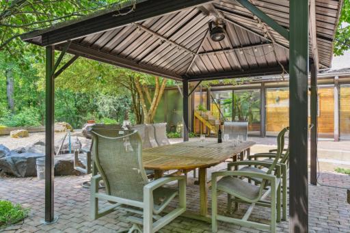 The spacious covered pergola is a favorite spot for enjoying outdoor meals, hosting gatherings, or simply relaxing with a glass of wine and a good book.