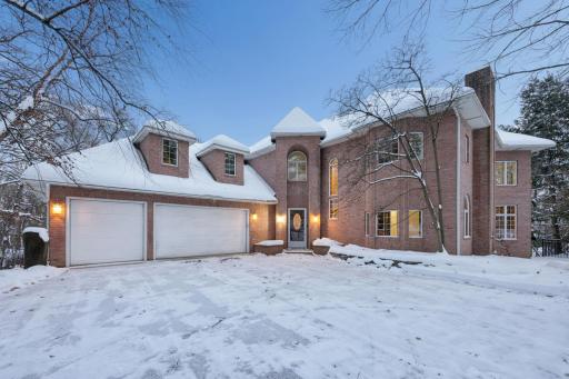 Elegant brick faÃ§ade adds timeless charm to the grand two-story entrance of the home, while the recently seal-coated driveway enhances both curb appeal and functionality.
