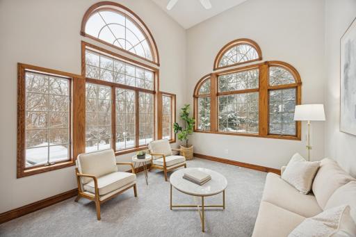 The sun room continues the theme of abundant natural light, with large windows, French doors, and new carpet. This versatile space is perfect as an inspiring workspace, music room, or creative retreat.