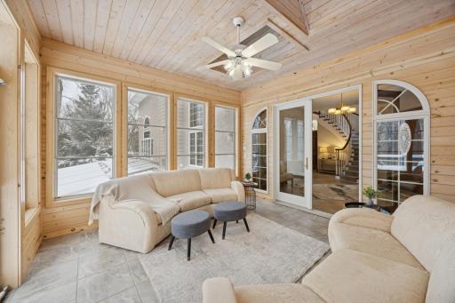 With windows on three sides and two skylights above, the three-season porch is drenched in natural light. Ideal for morning coffee or entertaining guests, the space is enhanced by tranquil views and the soothing sounds of nature.