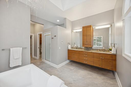Additional highlights include under-cabinet mood lighting, a skylight, porcelain flooring, and a spacious walk-in closet.