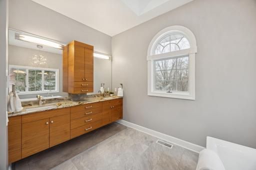 The ownerâs bathroom showcases a floating walnut vanity with dual sinks set in Brazilian marble. Enjoy the luxury of in-floor heated tiles that keep your feet warm and comfortable.
