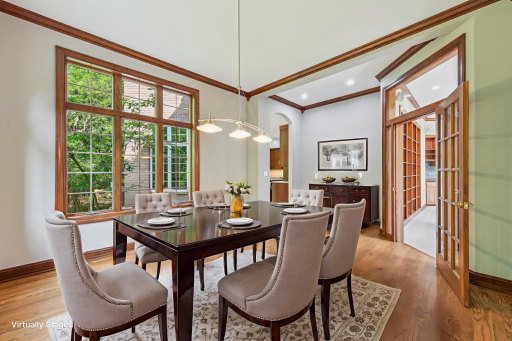 The formal dining room is spacious and filled with natural lightâan ideal setting for hosting memorable meals. It features rich oak wood floors, cherry crown molding and millwork, elegant lighting, large windows, and a soaring 10-foot ceiling!