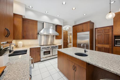 The Bluestar range with 8 burners and dual oven makes large meals easy. The Sub-Zero fridge is seamlessly integrated into mahogany cabinets next to the spacious pantry, while dual sinks make clean-up a breeze.