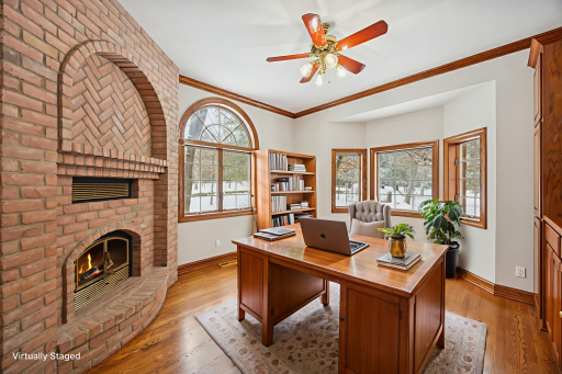 Quietly tucked away, the office features oak hardwood floors and a wood-burning fireplace with a classic brick surround. Warm wood tones create a cozy, inviting atmosphereâperfect for curling up with a favorite book.
*Digital fire effect added*