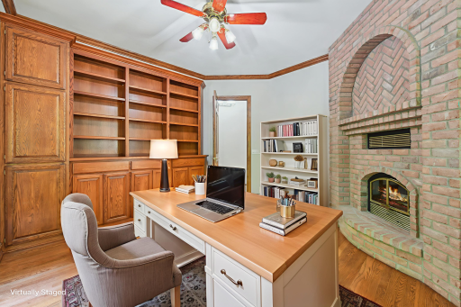 The office space is versatile, featuring crown molding, built-in bookshelves and cabinetryâmaking it an ideal space for a reading room, personal library or home office.
*Digital fire effect added*