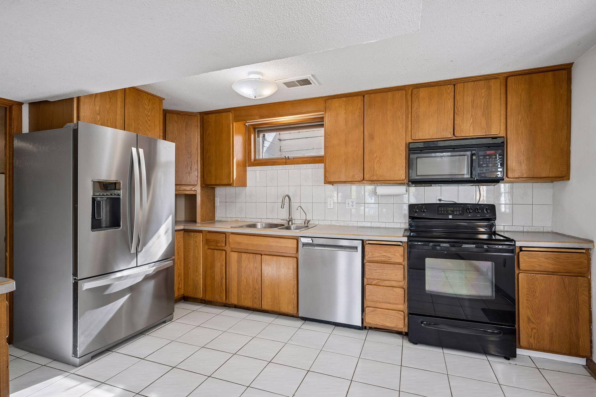 The kitchen has good storage space and some stainless steel appliances.