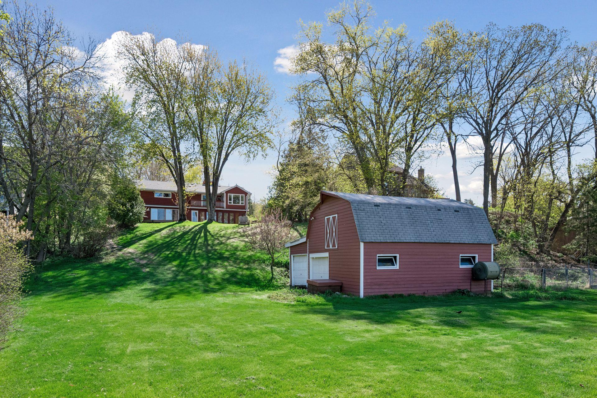 The back of the home and the extra large barn.