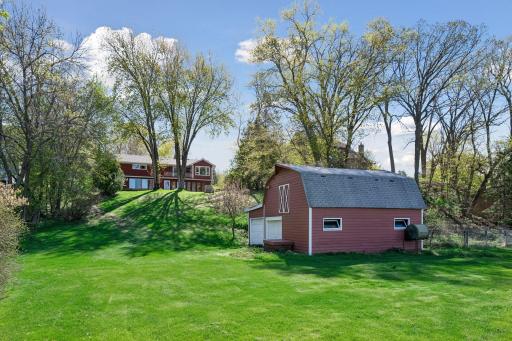 The back of the home and the extra large barn.