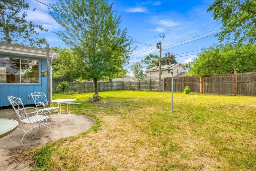 Step out of the kitchen and into this spacious fenced in back yard