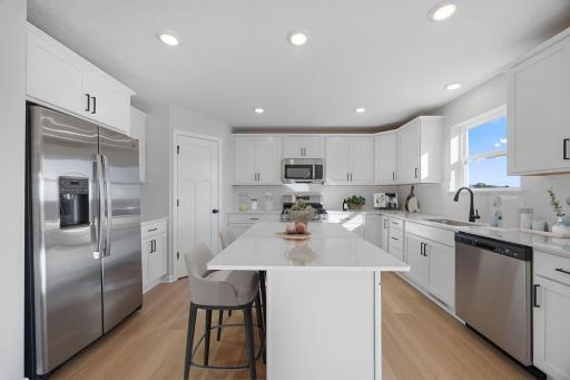 Welcome to the kitchen of the Richmond floorplan! Abundant storage, countertop and cabinet space. Must have corner pantry. All stainless steel appliances included. Microwave vented to the exterior.