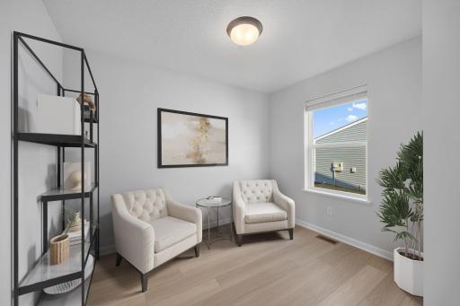 Flex room located off the garage. Perfect space for an office or play room. Virtually staged. Photo of the same floorplan in a different community.