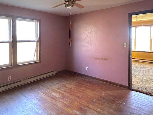 Main floor bedroom - just off of the living room - hardwood flooring ready for refinishing!
