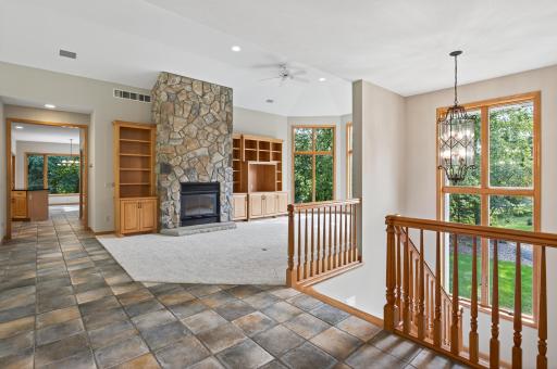 Main Level Living Room includes grand, soaring ceilings and wood-burning fireplace