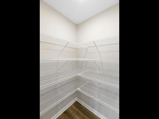 Photo of a different home with similar plan & finishes. Kitchen Walk-in Pantry. Photo may not depict actual plan & finishes.