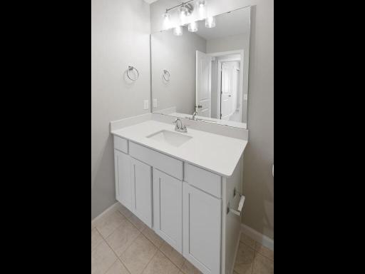 Photo of a different home with similar plan & finishes. Main full bathroom. Photo may not depict actual plan & finishes.