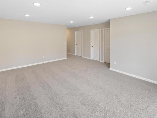 Photo of a different home with similar plan & finishes. Lower Level Family Room. Photo may not depict actual plan & finishes.