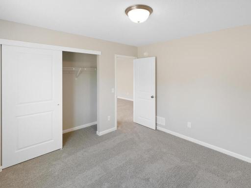 Photo of a different home with similar plan & finishes. Lower Level Bedroom 4. Photo may not depict actual plan & finishes.