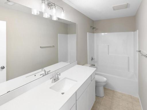 Photo of a different home with similar plan & finishes. Lower Level Full Bathroom. Photo may not depict actual plan & finishes.