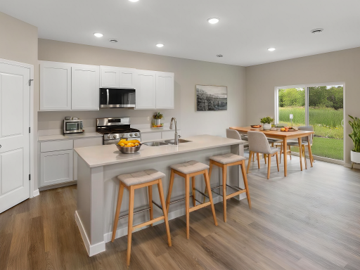 Kitchen and Dining Room, Virtually Staged. Photo taken of another home with similar plan and finishes. Photos and renderings may not depict actual plan, materials, & finishes may vary. All measurements are approximate.