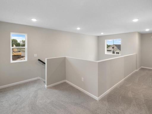Upper Level Landing. Photo taken of another home with similar plan and finishes. Photos and renderings may not depict actual plan, materials, & finishes may vary. All measurements are approximate.
