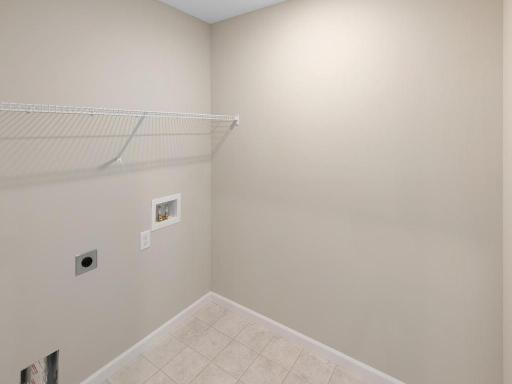 Upper Level Laundry Room. Photo taken of another home with similar plan and finishes. Photos and renderings may not depict actual plan, materials, & finishes may vary. All measurements are approximate.