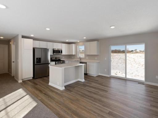 Kitchen and Dining Room. Photo is taken of another home with similar plan and finishes.