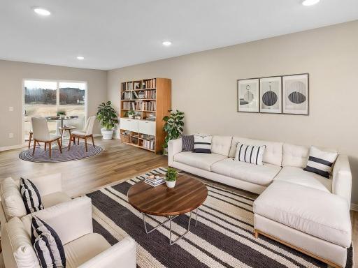 Living Room and Dining Room, Virtually Staged. Photo is taken of another home with similar plan and finishes.