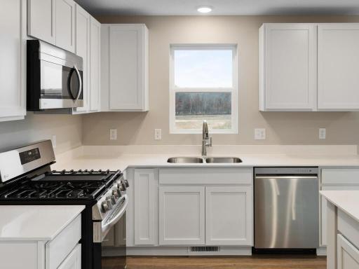 Kitchen. Photo is taken of another home with similar plan and finishes.