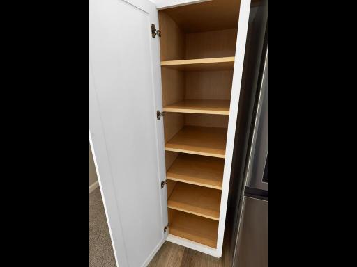 Kitchen Pantry Cabinet. Photo is taken of another home with similar plan and finishes.