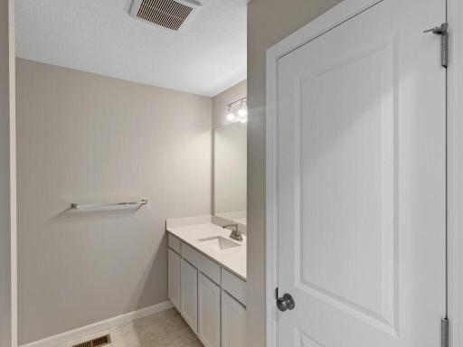 Main Level Bathroom. Photo is taken of another home with similar plan and finishes.