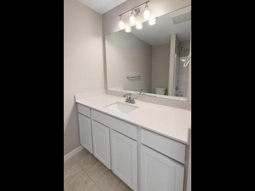 Main Level Bathroom. Photo is taken of another home with similar plan and finishes.