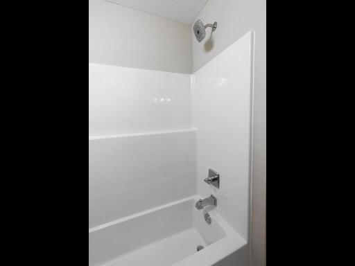 Main Level Bathroom. Photo is taken of another home with similar plan and finishes.