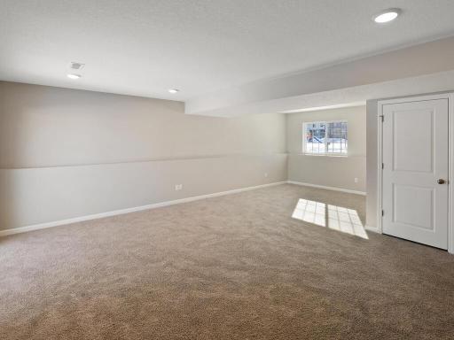 Lower Level Finished Family Room. Photo is taken of another home with similar plan and finishes.