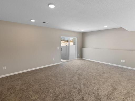 Lower Level Finished Family Room. Photo is taken of another home with similar plan and finishes.