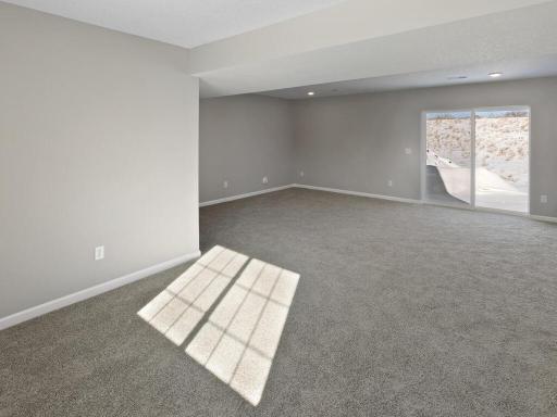 Lower Level Finished Family Room. Photo is taken of another home with similar plan and finishes.