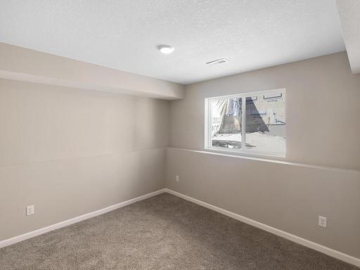 Lower Level Finished Bedroom 4. Photo is taken of another home with similar plan and finishes.