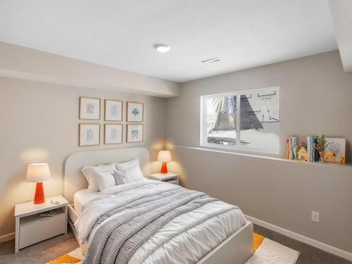 Lower Level Finished Bedroom 4, Virtually Staged. Photo is taken of another home with similar plan and finishes.