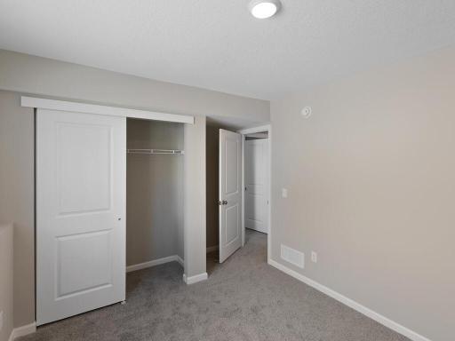 Lower Level Finished Bedroom 4. Photo is taken of another home with similar plan and finishes.