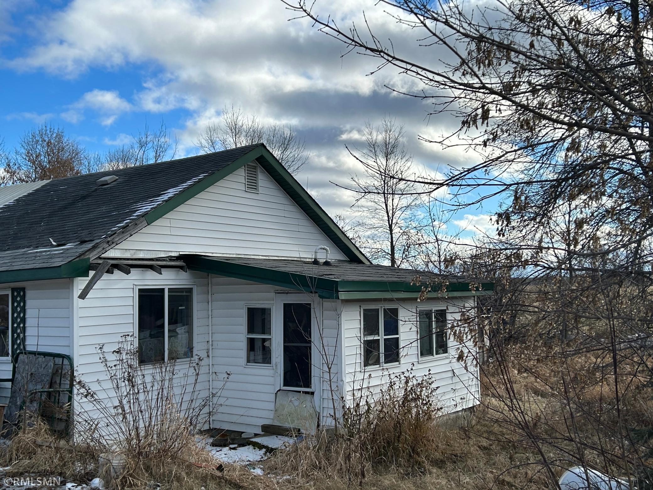 West side of house with furnace room/porch