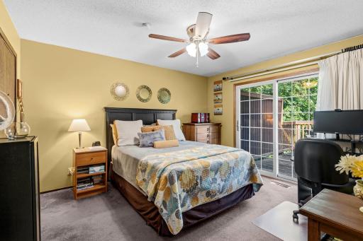 The primary bedroom with patio doors leading out to the deck. Lots of great lighting.