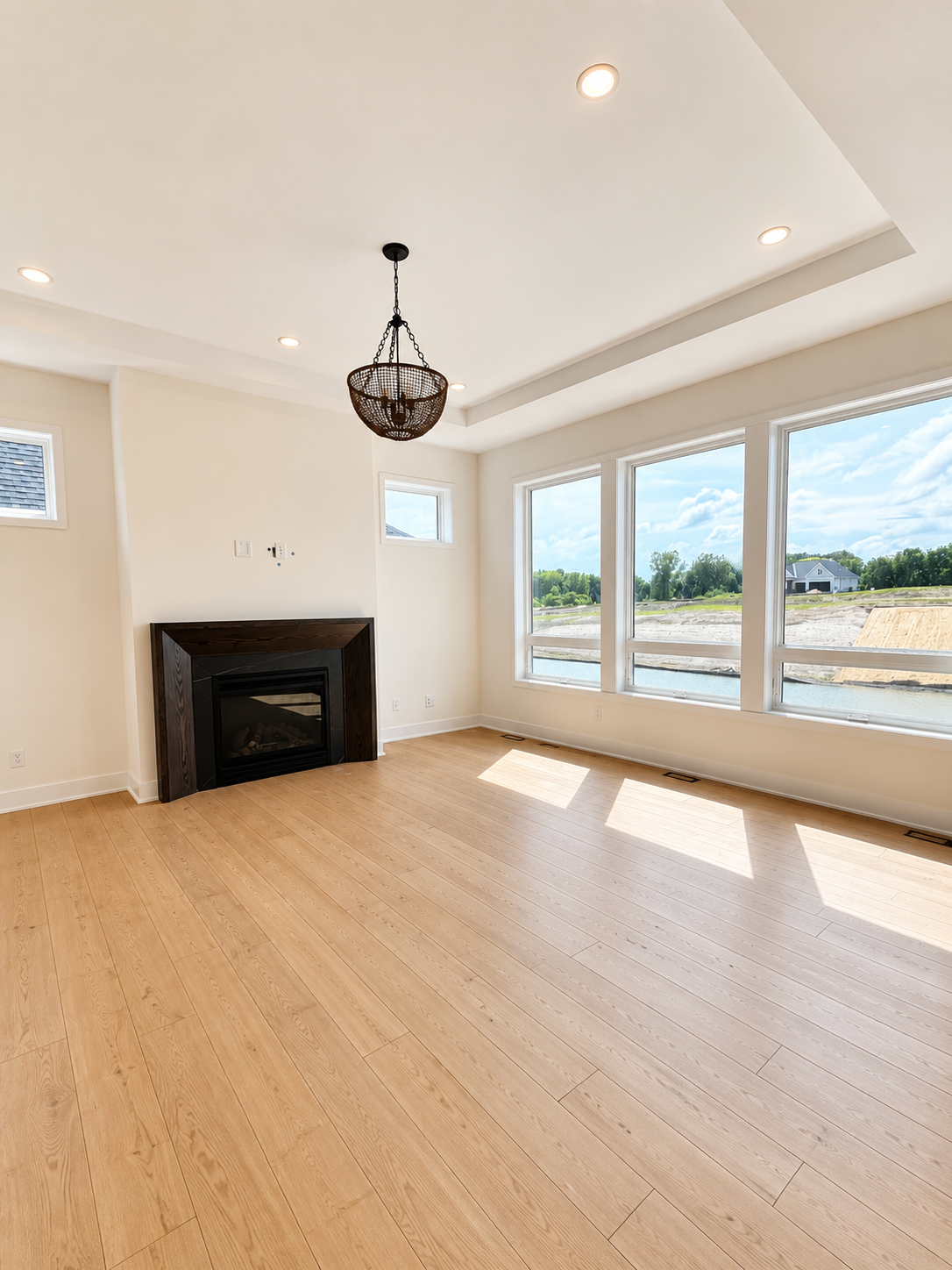 Light-filled great room with expansive windows, soaring ceilings, and seamless indoor-outdoor views—perfect for everyday living and entertaining.
