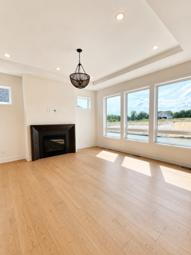 Light-filled great room with expansive windows, soaring ceilings, and seamless indoor-outdoor viewsâperfect for everyday living and entertaining.