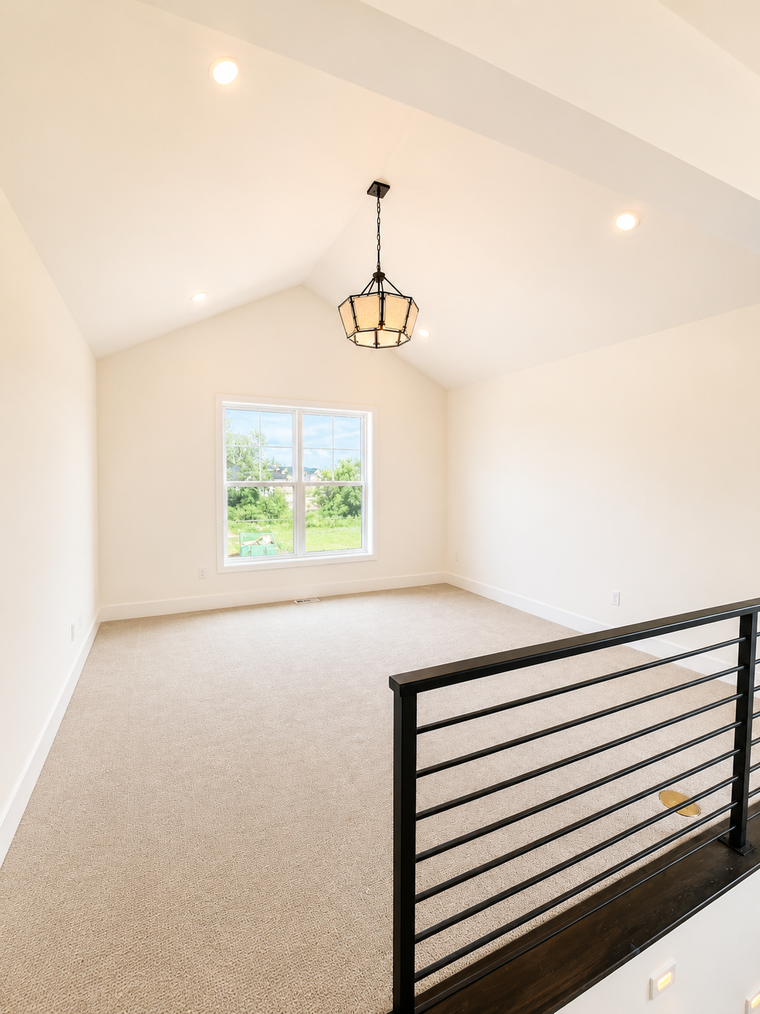 A bright and inviting loft anchors the upper level, creating a comfortable gathering space while three additional bedrooms offer privacy and flexibility for family and guests.