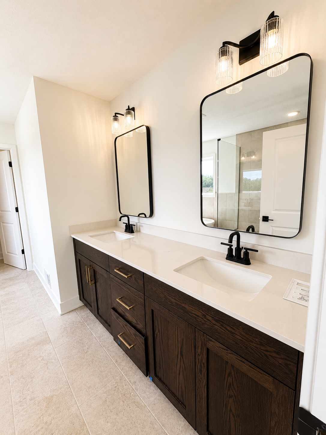 Spa-inspired owner's bath featuring a freestanding soaking tub, oversized tiled walk-in shower, dual vanity, and designer finishes throughout.