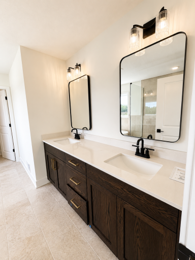 Spa-inspired owner's bath featuring a freestanding soaking tub, oversized tiled walk-in shower, dual vanity, and designer finishes throughout.