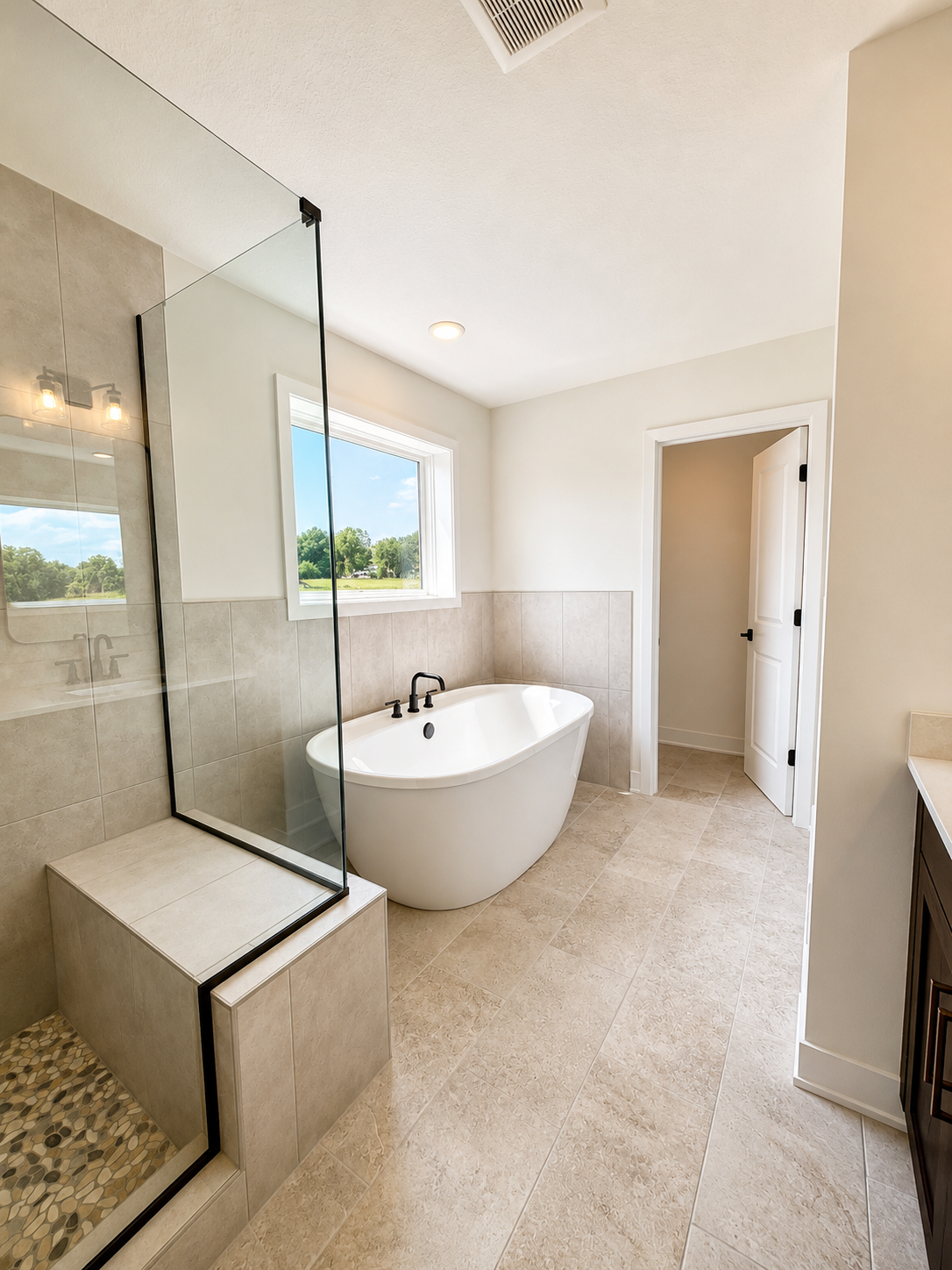 Spa-inspired owner's bath featuring a freestanding soaking tub, oversized tiled walk-in shower, dual vanity, and designer finishes throughout.