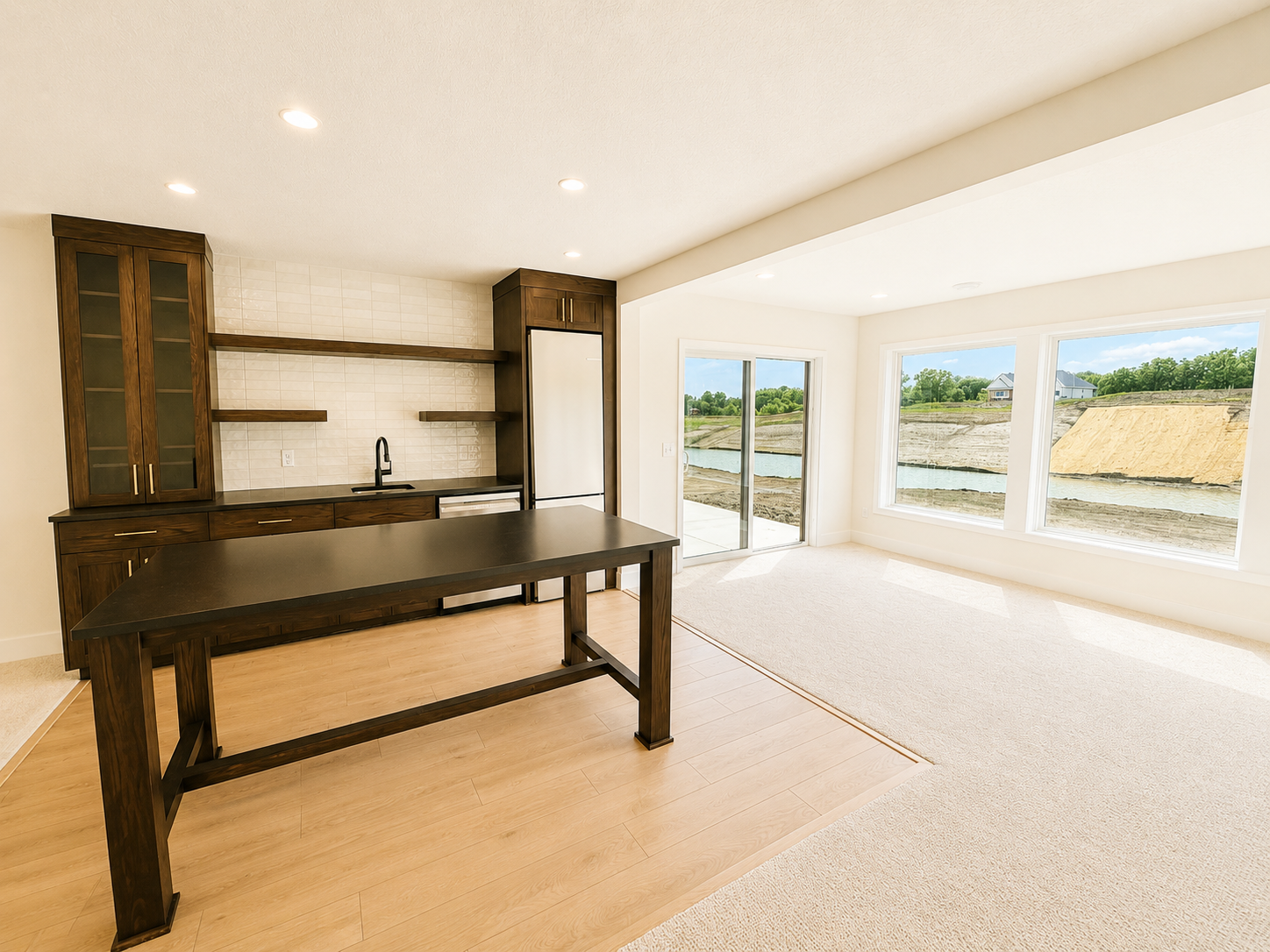 Elegant lower-level wet bar with custom cabinetry, floating shelves, beverage refrigerator, and quartz countertops—ideal for entertaining.