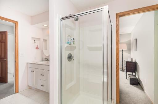 Ensuite primary bath offers a spa-like experience with a soaking tub and separate shower.