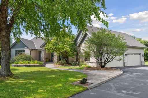 A graceful entrance with mature landscaping and refreshed drive way.